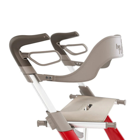 Close-up angled view of the grey byACRE Carbon Ultralight backrest securely mounted to a red rollator frame, providing ergonomic seat support.