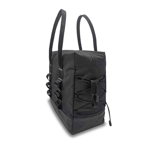 Black byACRE Daypack, angled side view showing its elastic storage cord