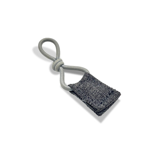 Standalone view of the compact byACRE Travel Lock, featuring a grey lock block and a high-strength, plastic-coated steel cable designed for robust rollator security.