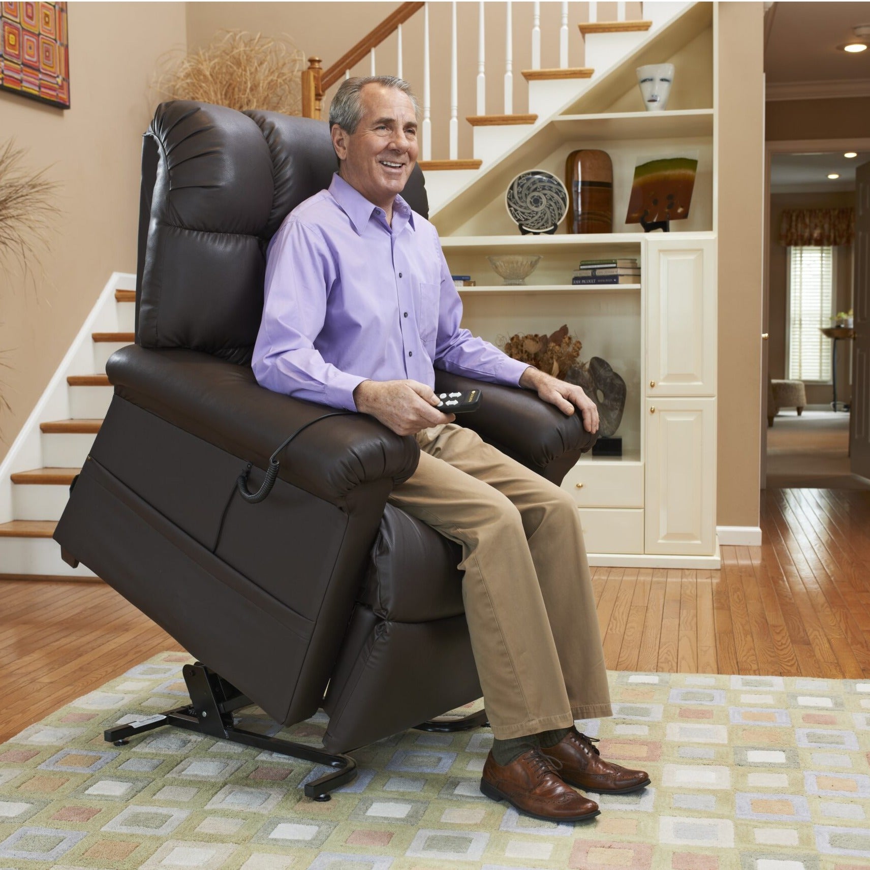 Man seated in his Golden Cloud PR510 lift chair with the seat raised to help him stand