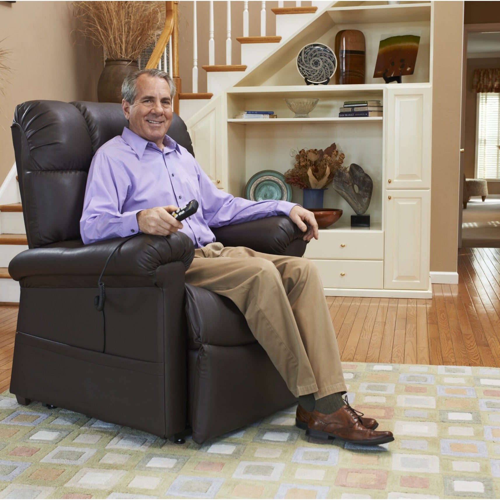 Man sitting comfortably in his Golden Cloud PR510 lift chair in a living room