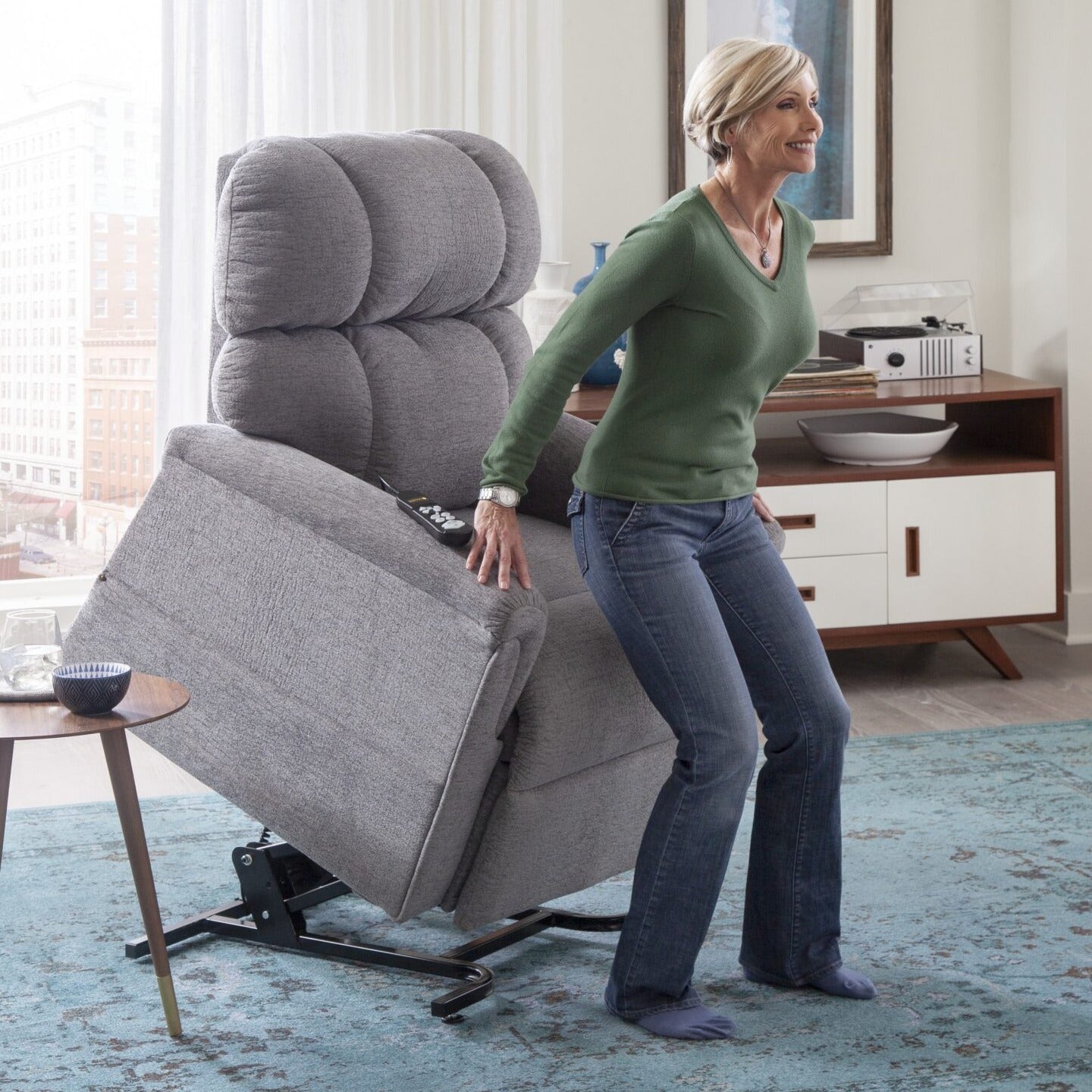 Woman standing up from her Golden MaxiComforter PR535 lift chair with the seat fully raised