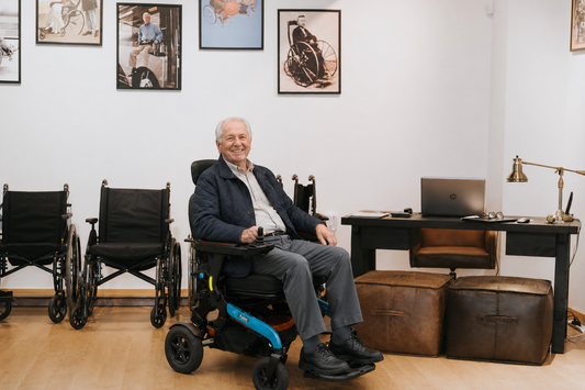 Smiling senior man using a folding electric wheelchair indoors in Canada