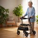 Senior woman using a rollator walker at home in Canada