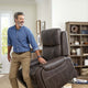 Man standing beside a raised Golden Titan PL449 lift chair in a living room