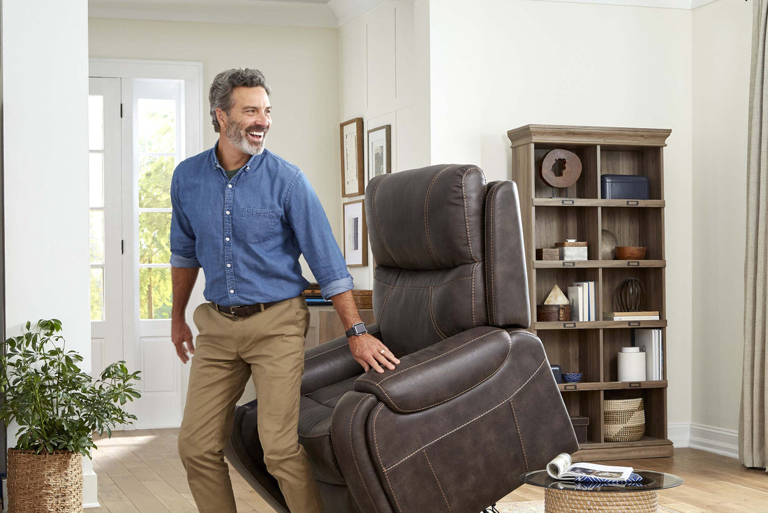Man standing beside a raised Golden Titan PL449 lift chair in a living room