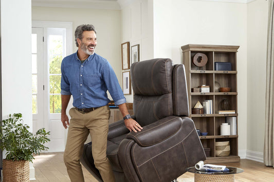 Man standing beside a raised Golden Titan PL449 lift chair in a living room