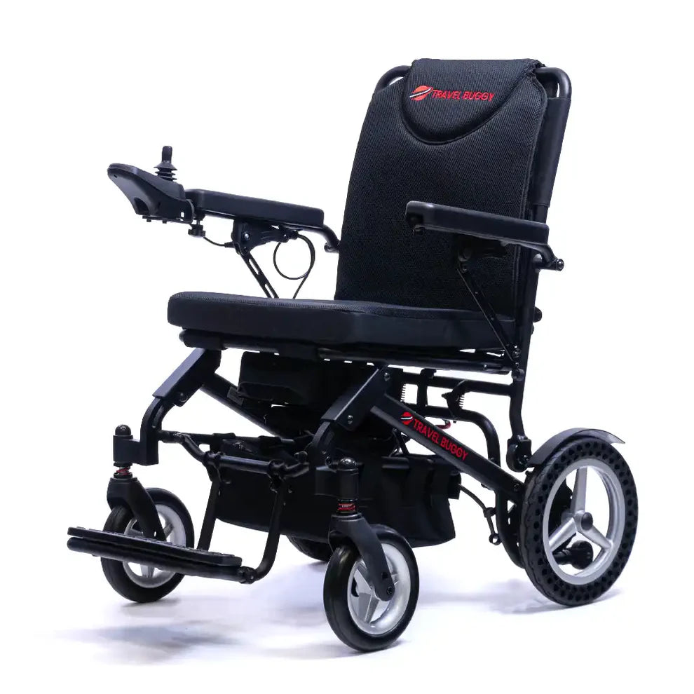 Angled left view of the Travel Buggy Dash lightweight foldable power wheelchair highlighting the joystick and armrests.