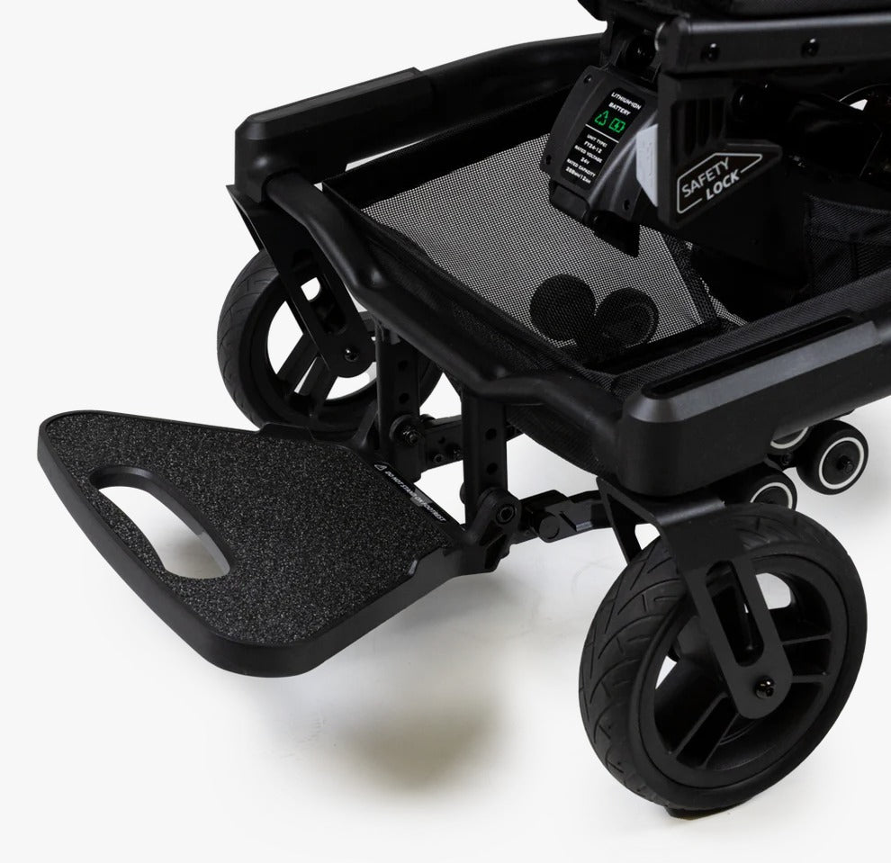Close-up of the wide footrest, front wheels, and under-seat safety lock on the Travel Buggy Grand Tourer GT.