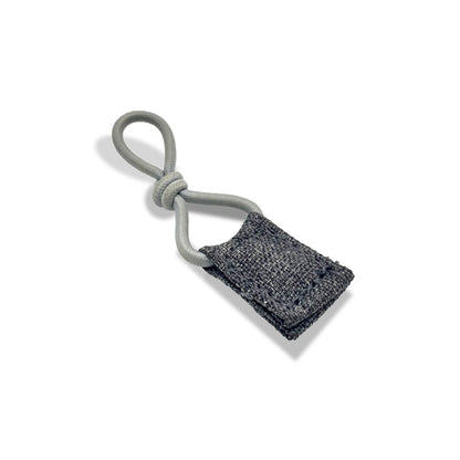 Standalone view of the compact byACRE Travel Lock, featuring a grey lock block and a high-strength, plastic-coated steel cable designed for robust rollator security.