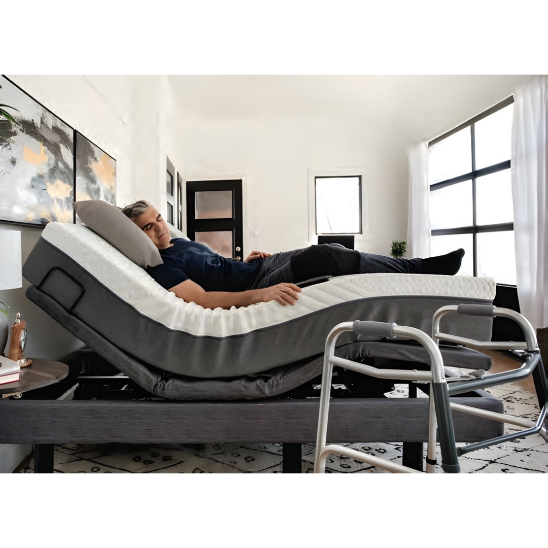 Lifestyle image showing a caregiver easily assisting a man using the elevated height feature of the Harmony Hi-Low bed.