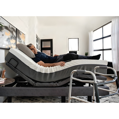 Lifestyle image showing a caregiver easily assisting a man using the elevated height feature of the Harmony Hi-Low bed.