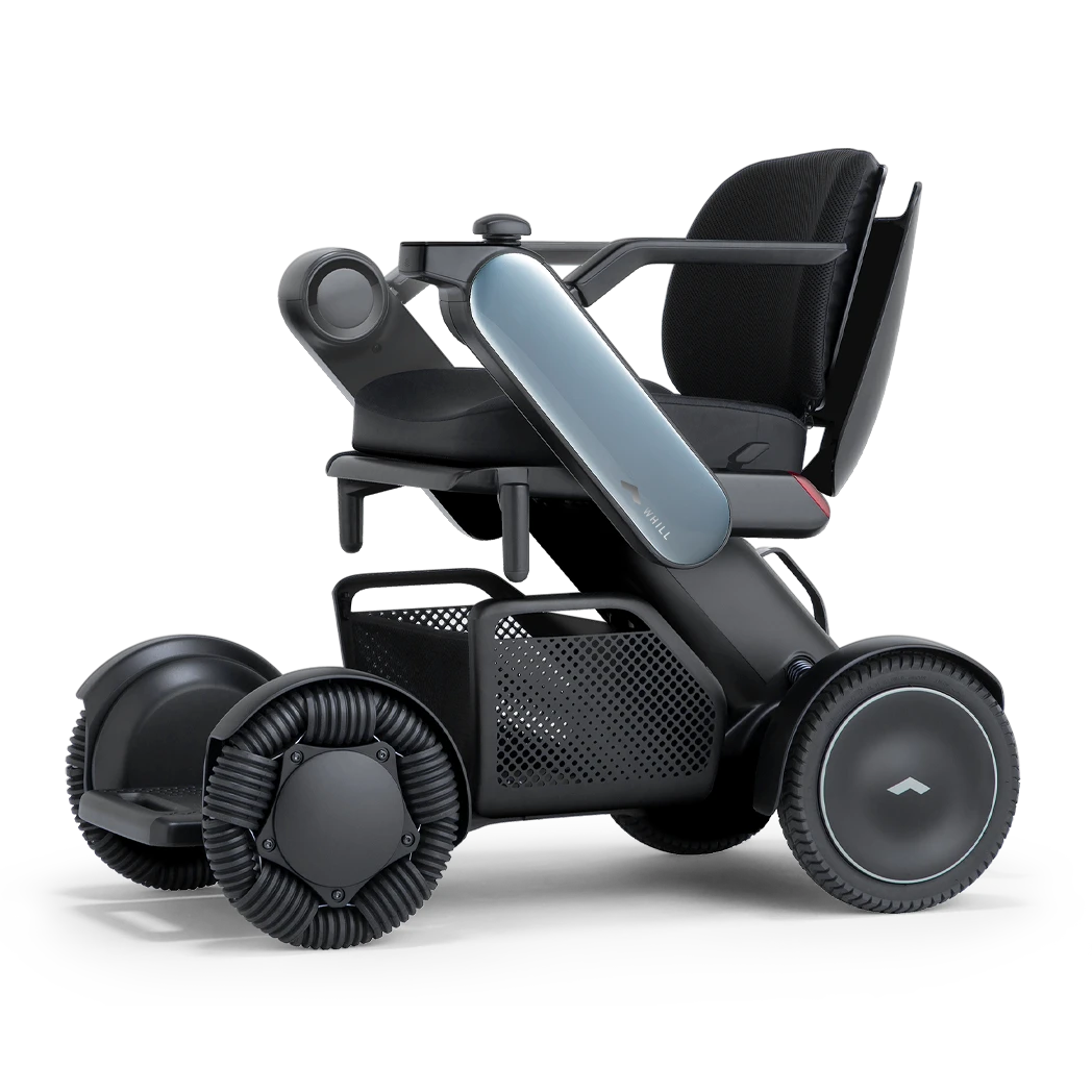 WHILL Model C2 power wheelchair with blue arm covers, front three-quarter studio view