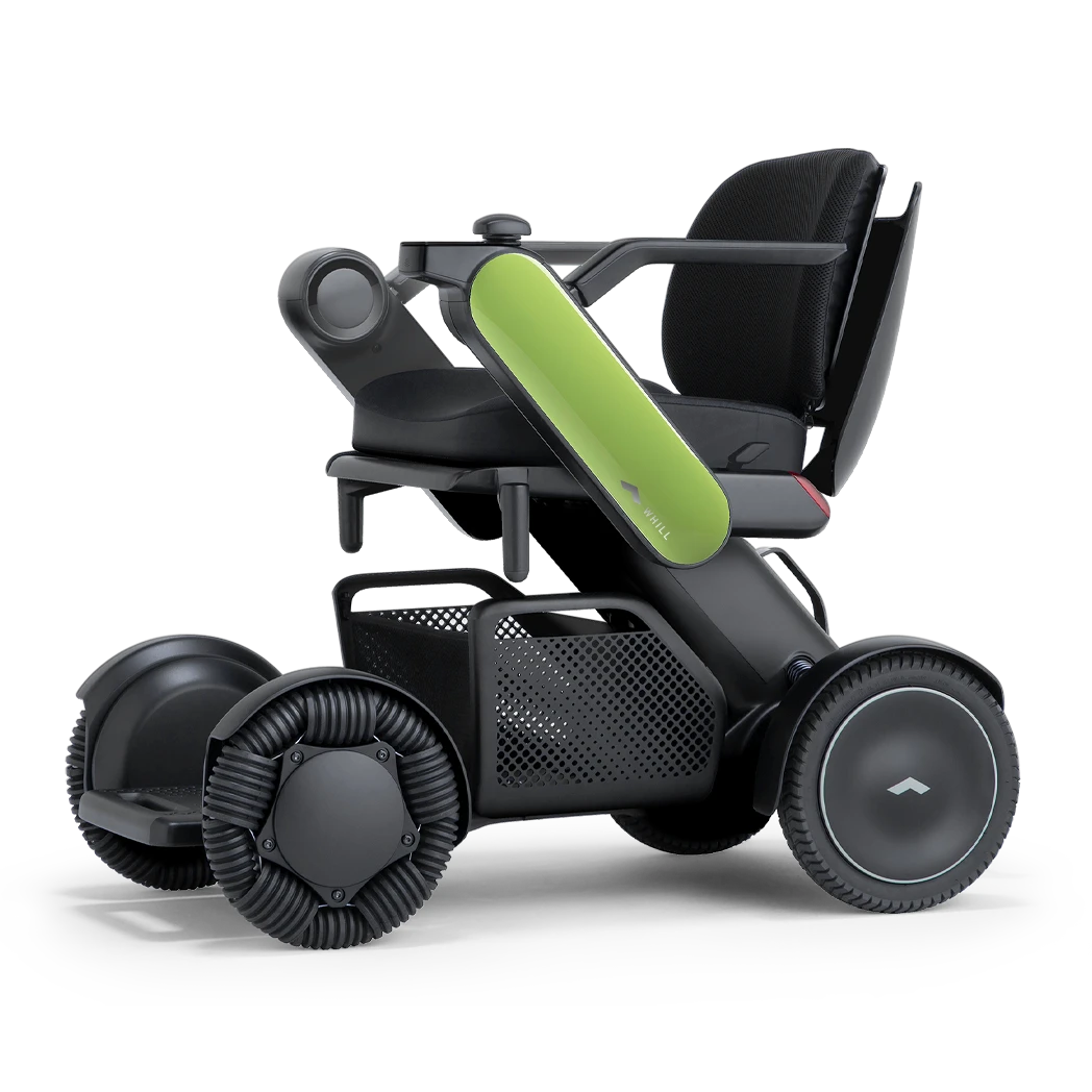 WHILL Model C2 power wheelchair with light green arm covers, front three-quarter studio view