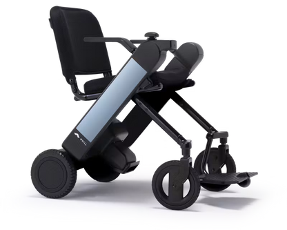 WHILL Model F power wheelchair with light blue arm covers, rear three-quarter studio view