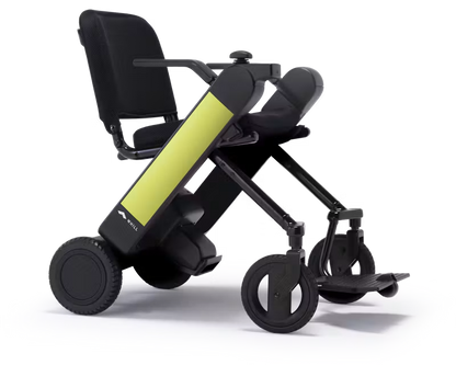 WHILL Model F power wheelchair with light green arm covers, rear three-quarter studio view