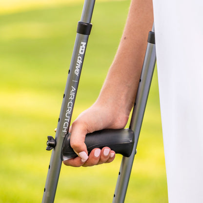 Close-up of a user's hand comfortably holding the ergonomic gel grip of the Drive Medical Air-Crutch.
