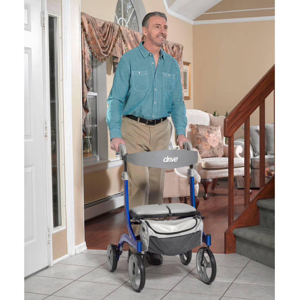Man using the Drive Medical Nitro DLX Rollator in blue for indoor mobility support.