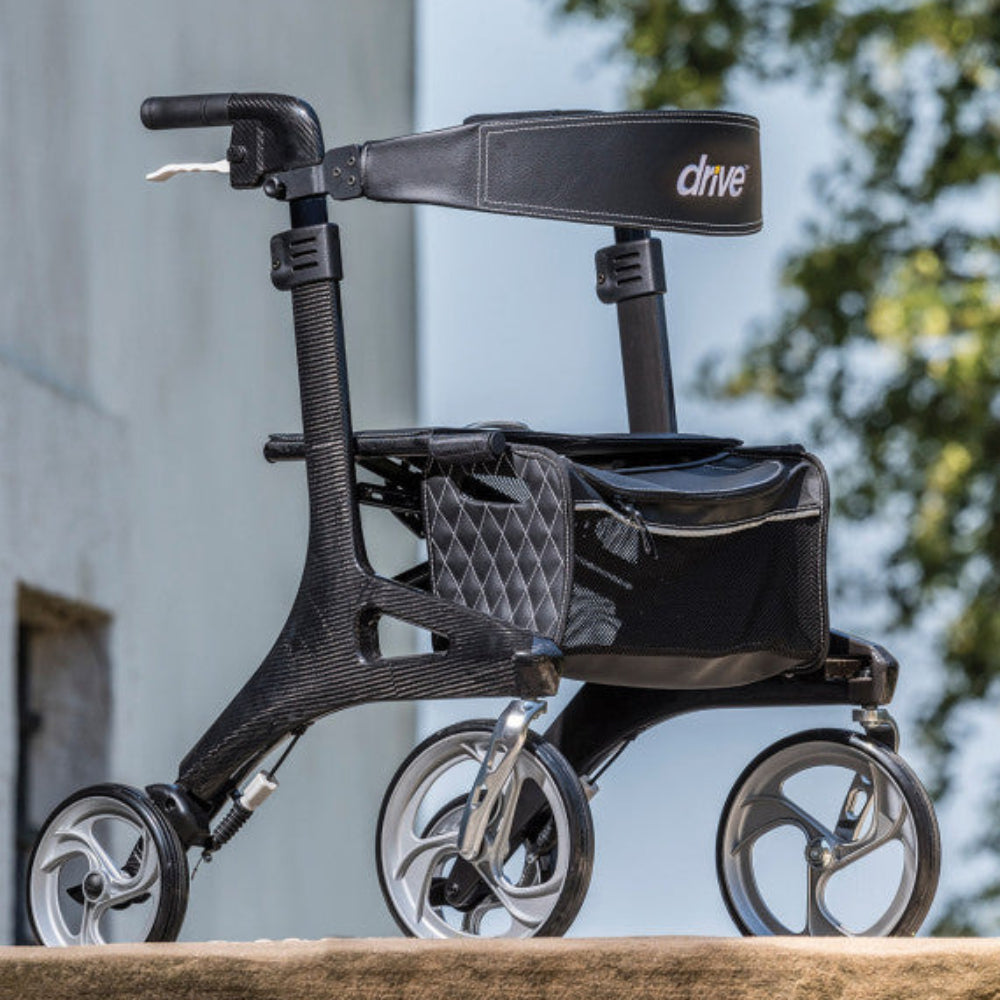 Senior using the lightweight Drive Nitro Elite Carbon Fiber Rollator outdoors.