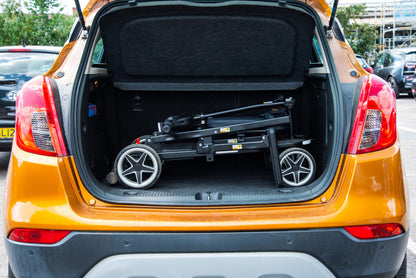 Folded eFOLDi Compass stowed in a car cargo area