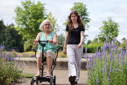 Rider using the eFOLDi Compass on a garden path, shown with optional armrests