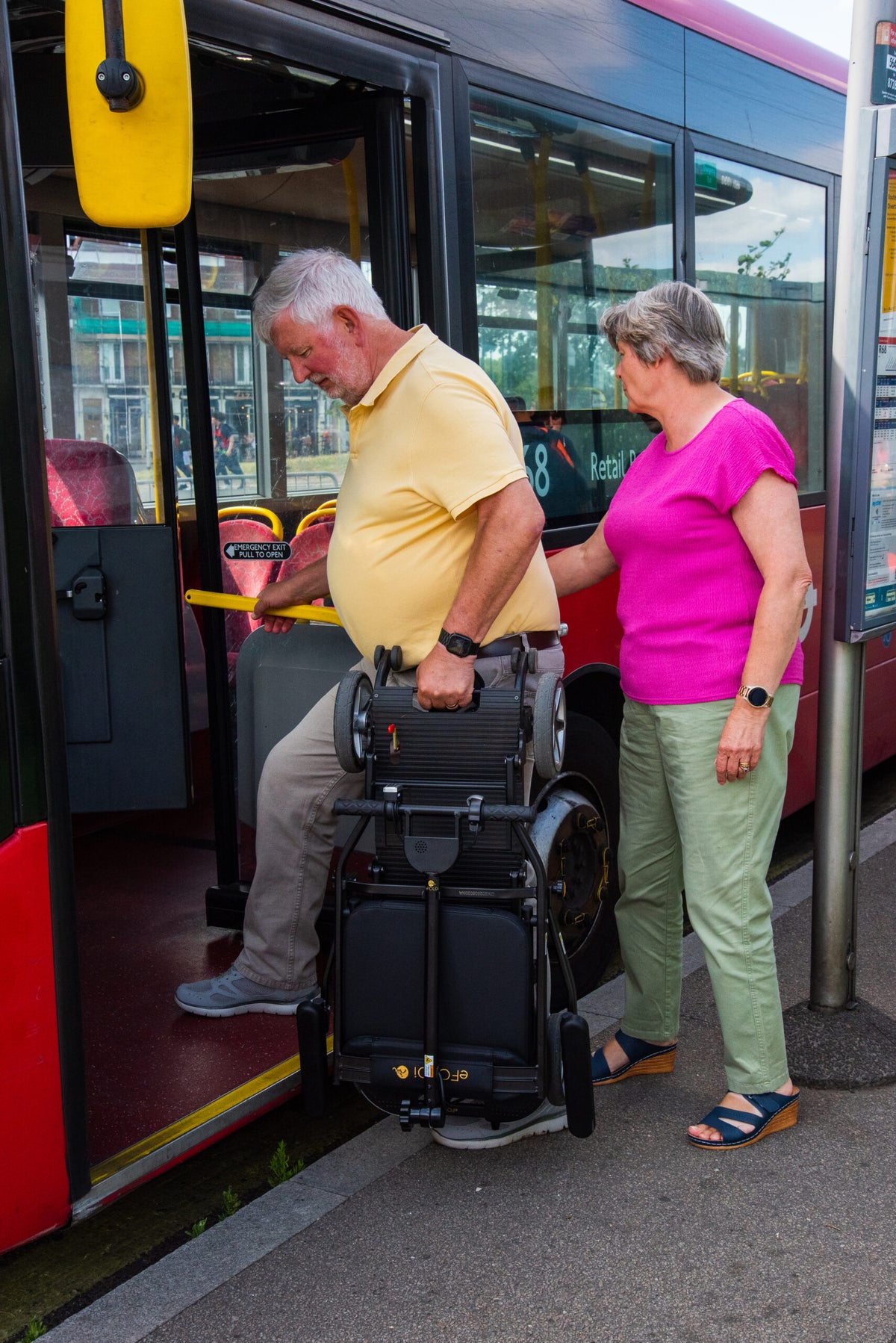 Folded eFOLDi Compass being carried onto a bus