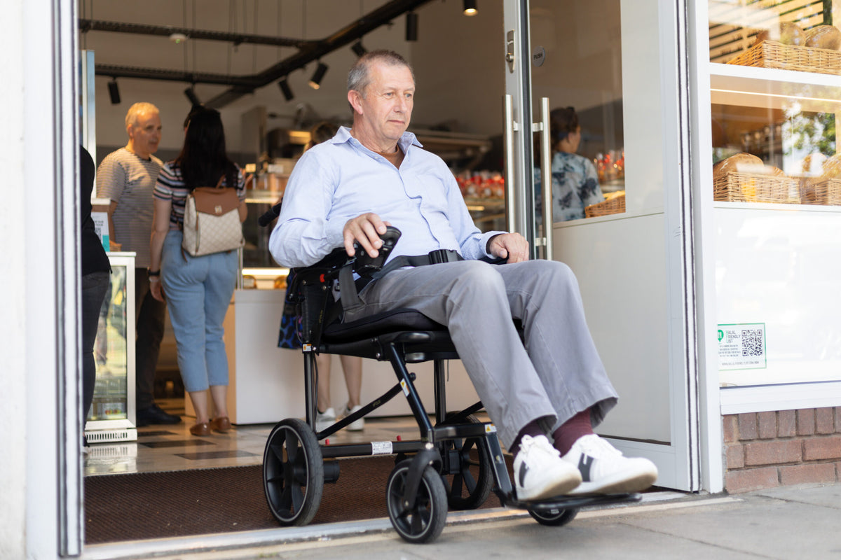 eFOLDi Navigator power wheelchair being used outside a shop