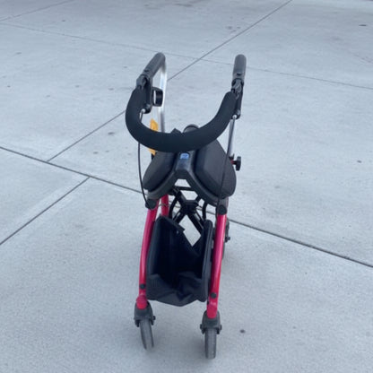 The Evolution Xpresso Lite rollator folded compactly side-to-side in a secure, self-standing upright position.