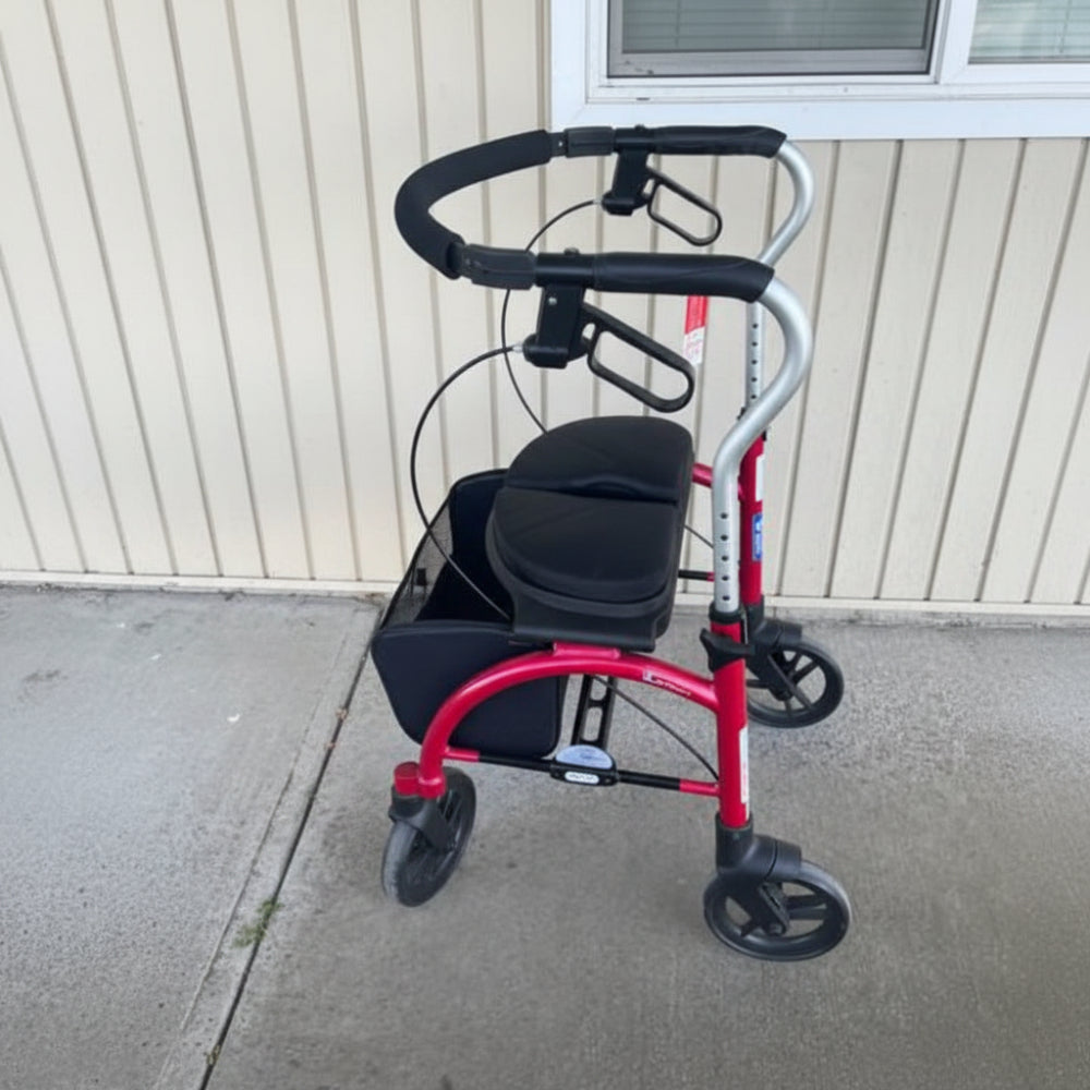 Side profile of the red Evolution Xpresso Lite rollator indoors, highlighting its smooth-rolling 4-wheel design and ergonomic handles.