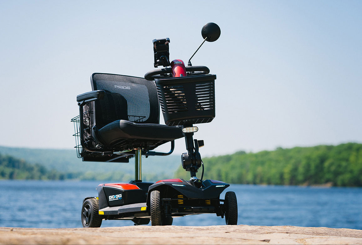 Pride Go-Go Endurance AL+ scooter parked beside a lake