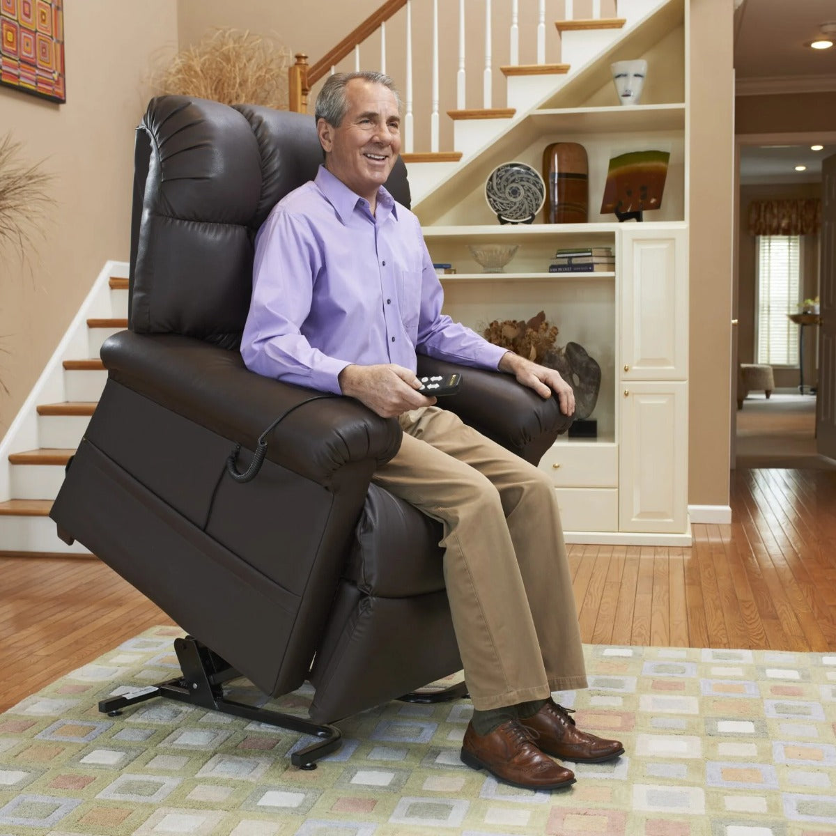 Man seated in his Golden Cloud PR510 lift chair with the seat raised to help him stand