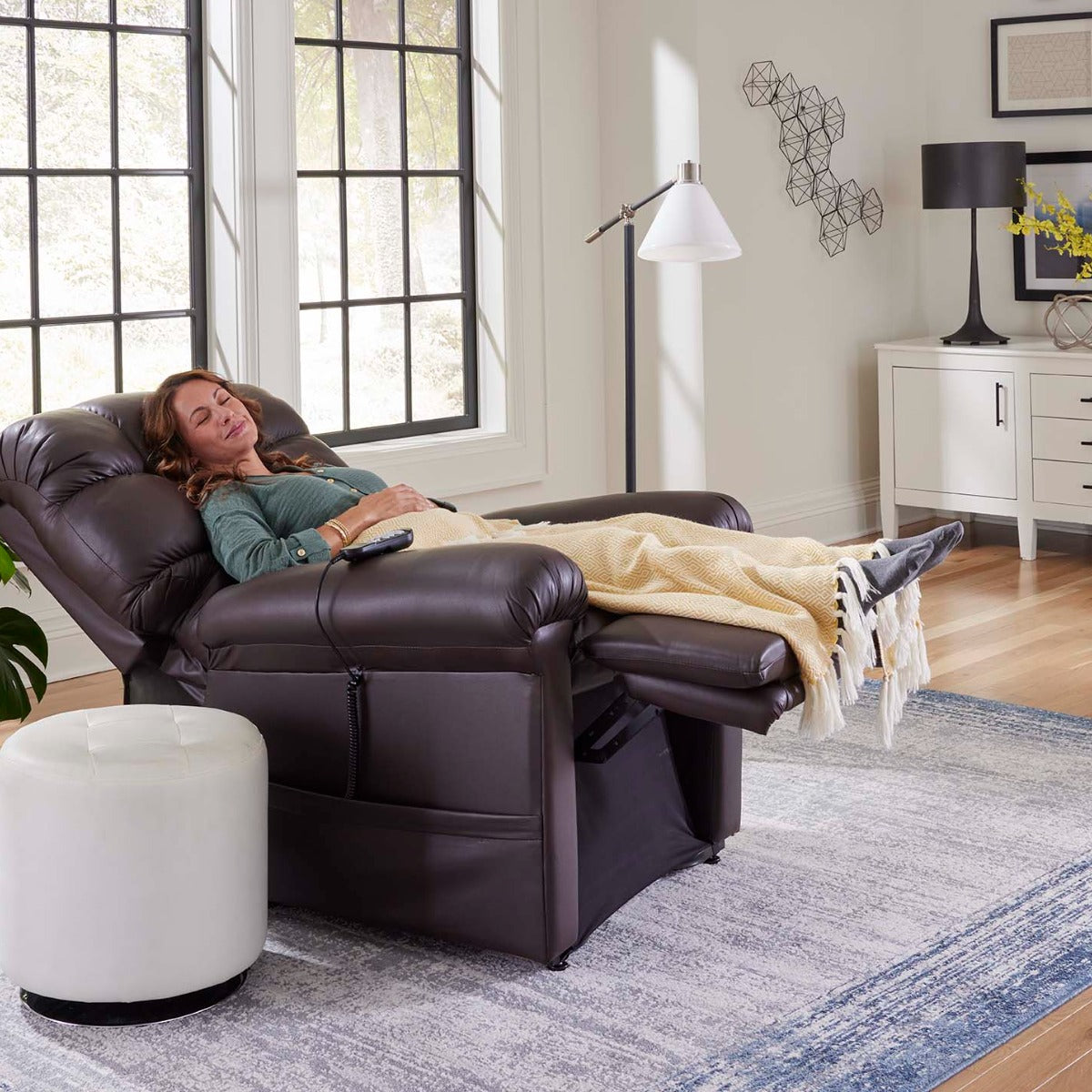 Woman asleep under a blanket in a fully reclined Golden Cloud PR510 lift chair