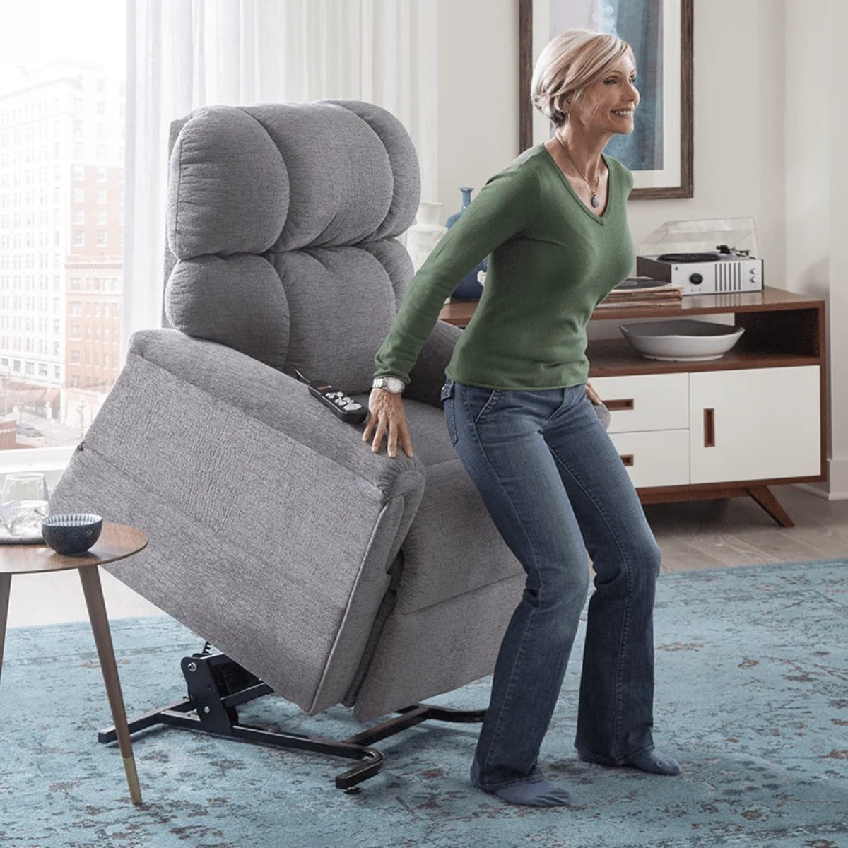 Woman standing up from her Golden MaxiComforter PR535 lift chair with the seat fully raised