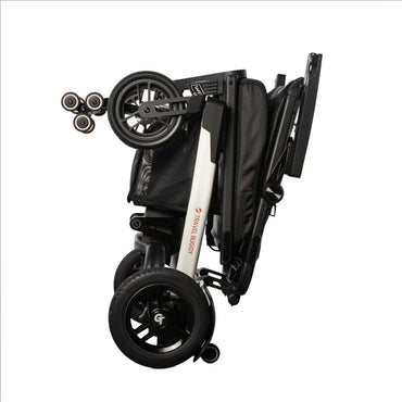 Travel Buggy Grand Tourer GT folded flat for convenient transport in a car trunk.