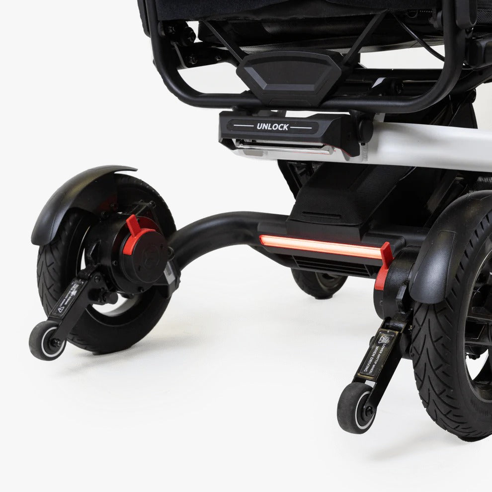 Close-up of the anti-tip wheels and secure unlock latch on the Travel Buggy Grand Tourer GT.