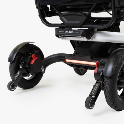 Close-up of the anti-tip wheels and secure unlock latch on the Travel Buggy Grand Tourer GT.