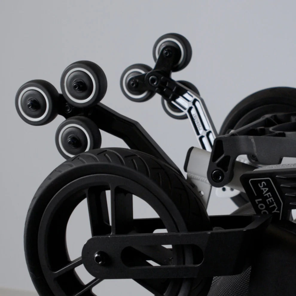 Detail view of the large rear drive wheels and anti-tip safety wheels on the Grand Tourer GT.