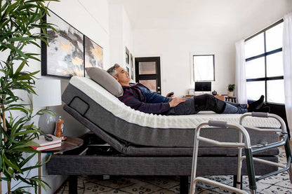 Lifestyle shot of a man resting comfortably in the contoured, zero-gravity position on the Harmony Hi-Low bed.
