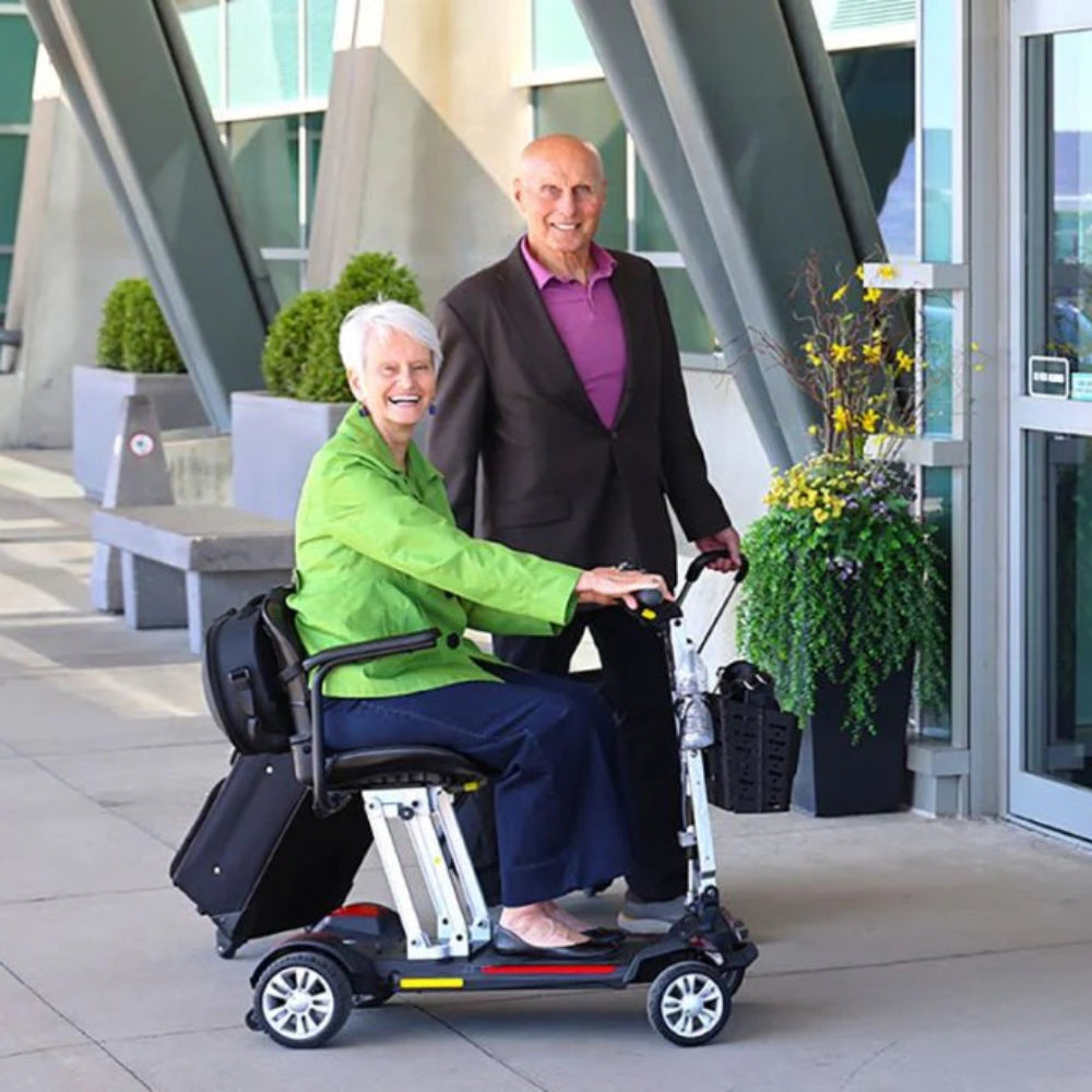 Lifestyle shot of a man enjoying an outdoor ride on a paved path using the Buzzaround CarryOn mobility scooter.