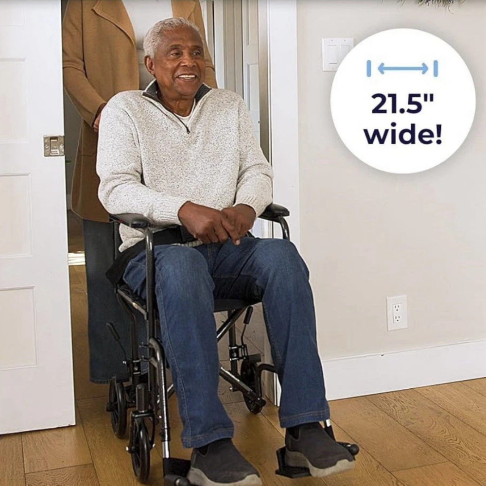 Lifestyle shot of a senior man comfortably sitting in the Drive Medical Steel Transport Chair indoors.