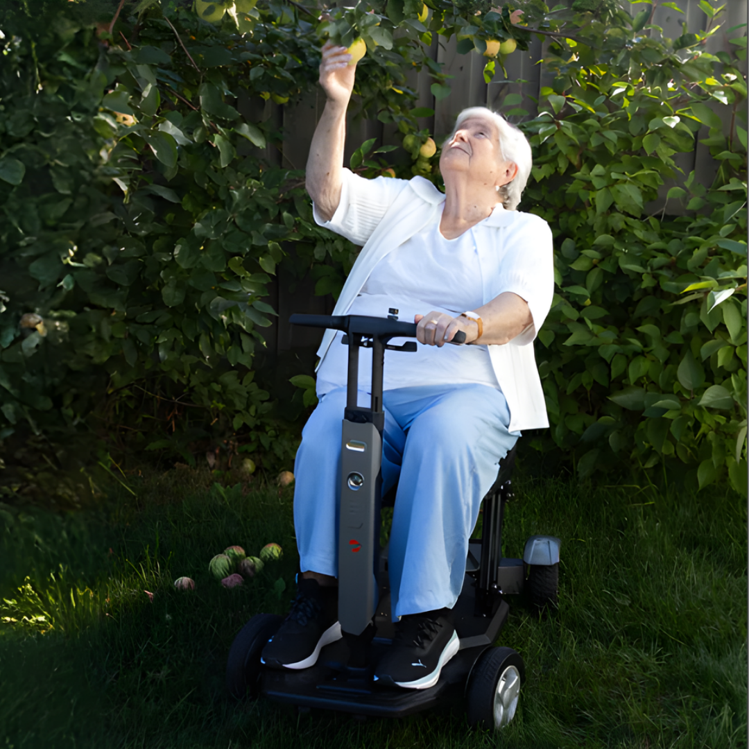 Lifestyle image of a happy senior man waving while comfortably driving his Travel Buggy HELIX mobility scooter.