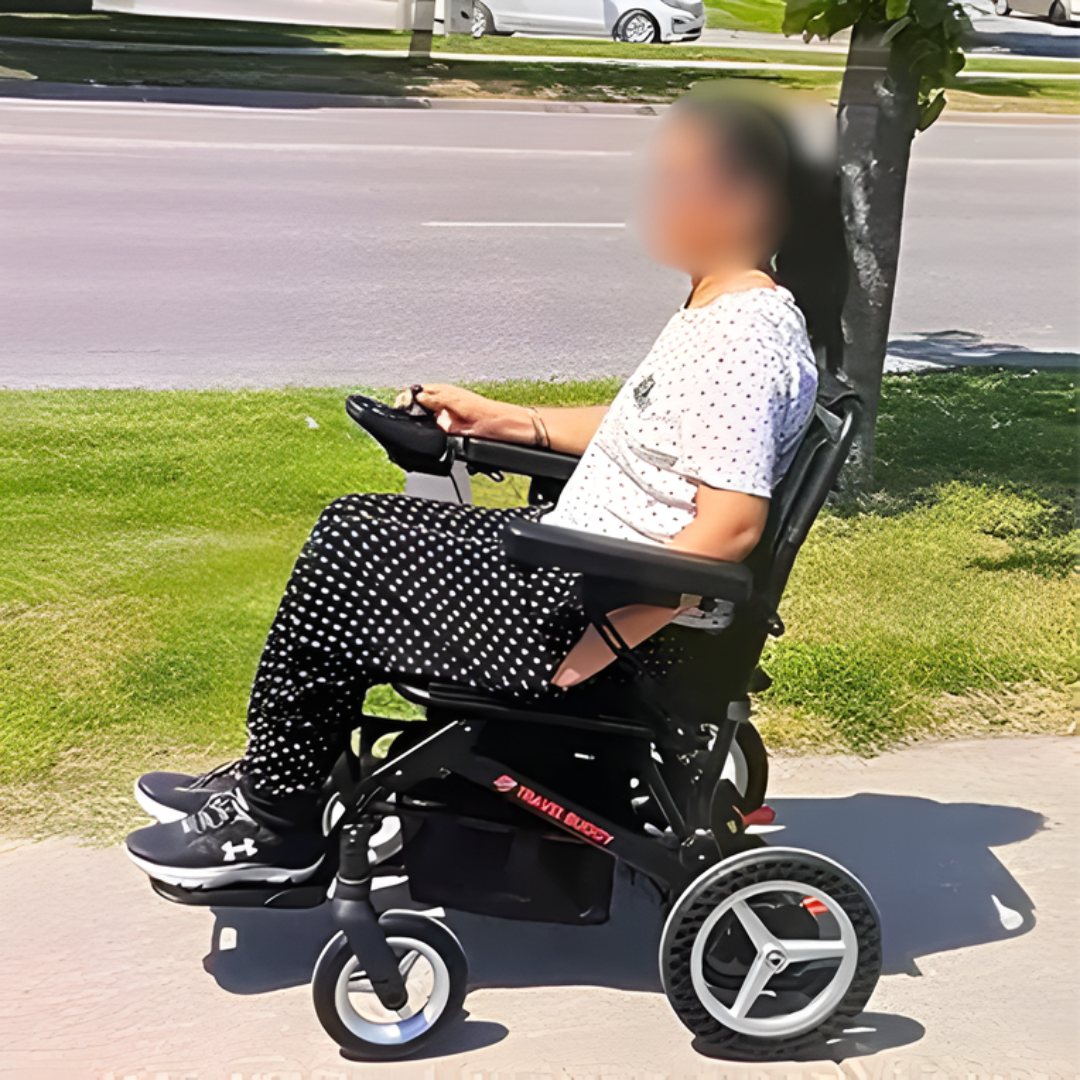 Lifestyle image of a user confidently driving the Dash power wheelchair along a paved outdoor sidewalk.