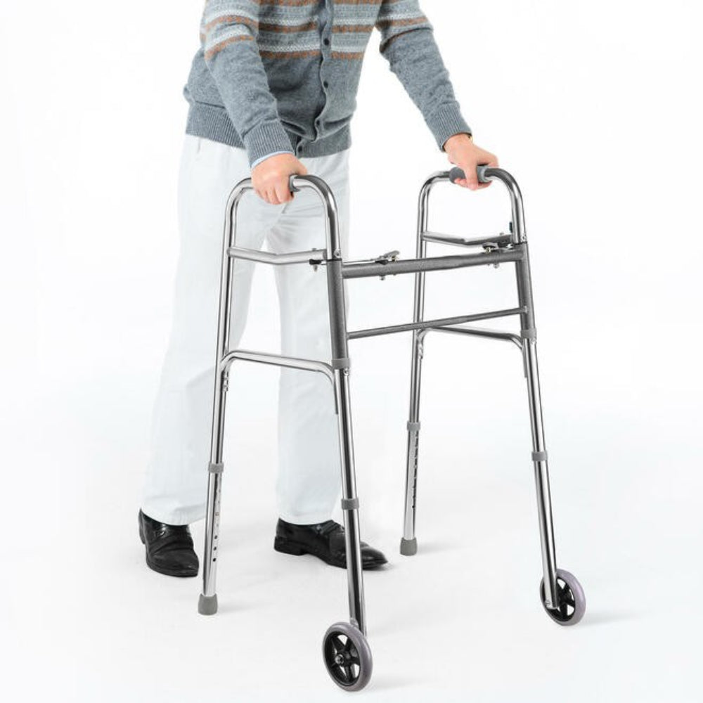 Person holding a Drive Medical two-button folding walker indoors