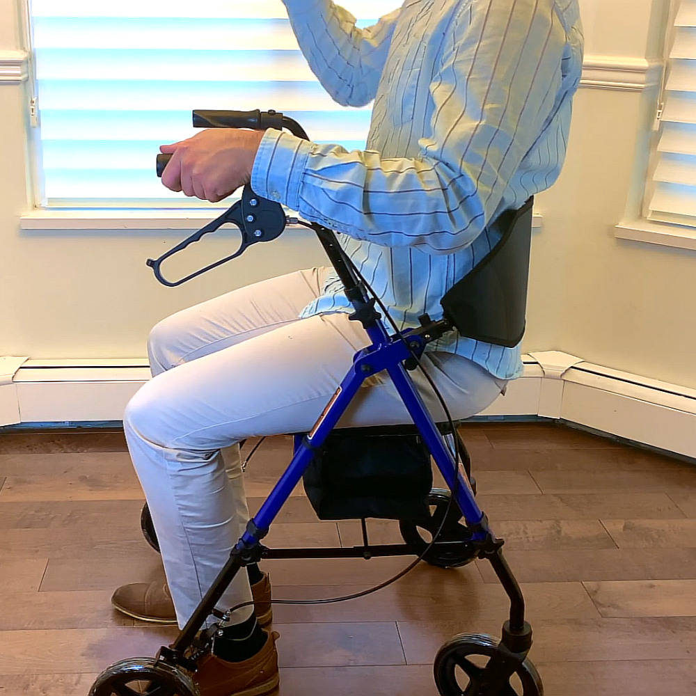 Person seated on a Blue MOBB aluminum four-wheel rollator indoors