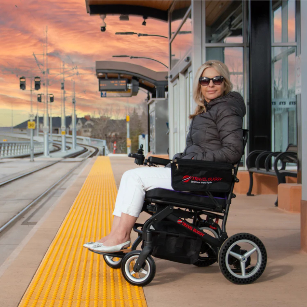 Lifestyle shot of a person easily navigating public transit train doors using the Dash by Travel Buggy power wheelchair.