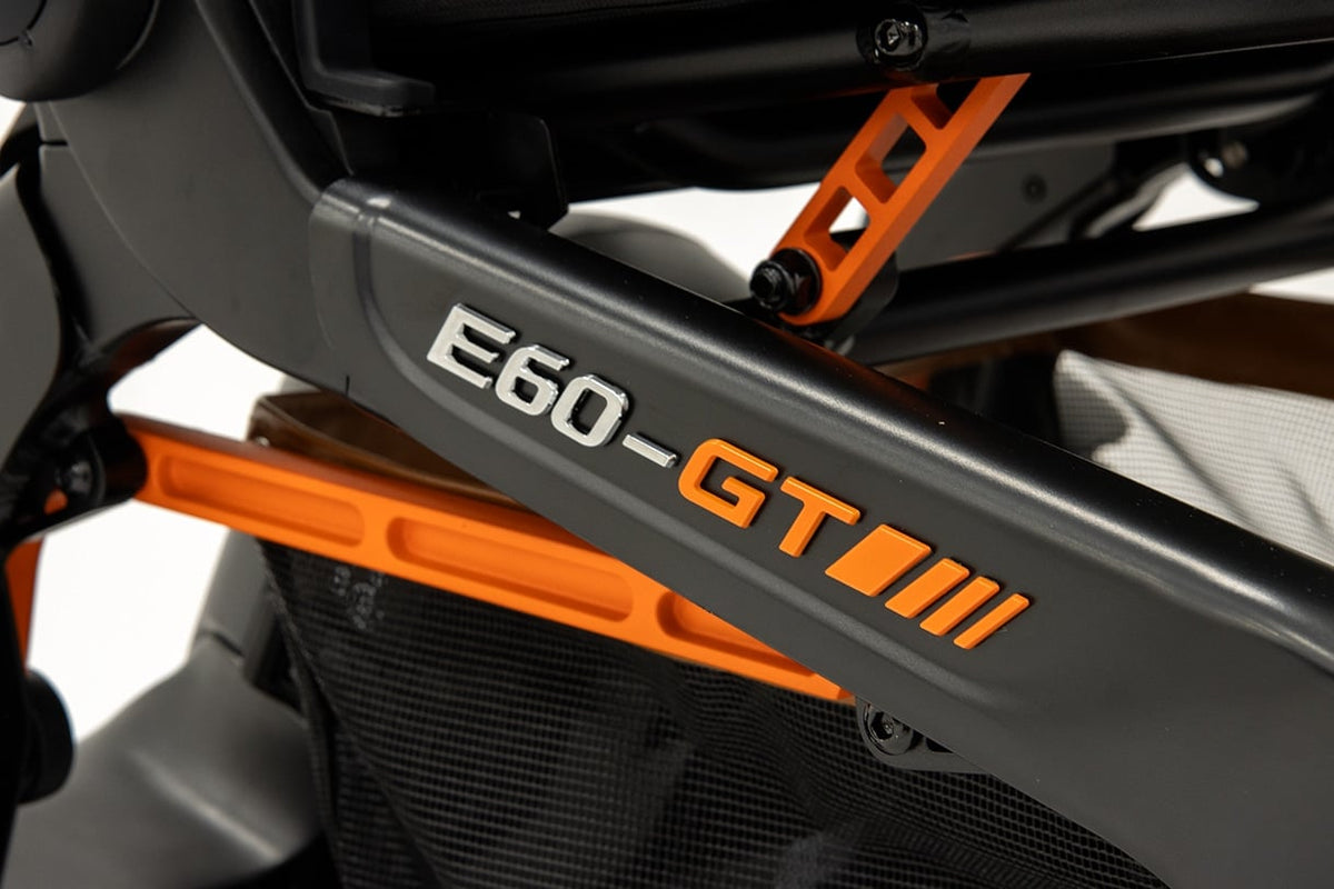 The E60-GT badge on the frame of the Robooter E60 Pro GT, in chrome and orange against the dark grey frame