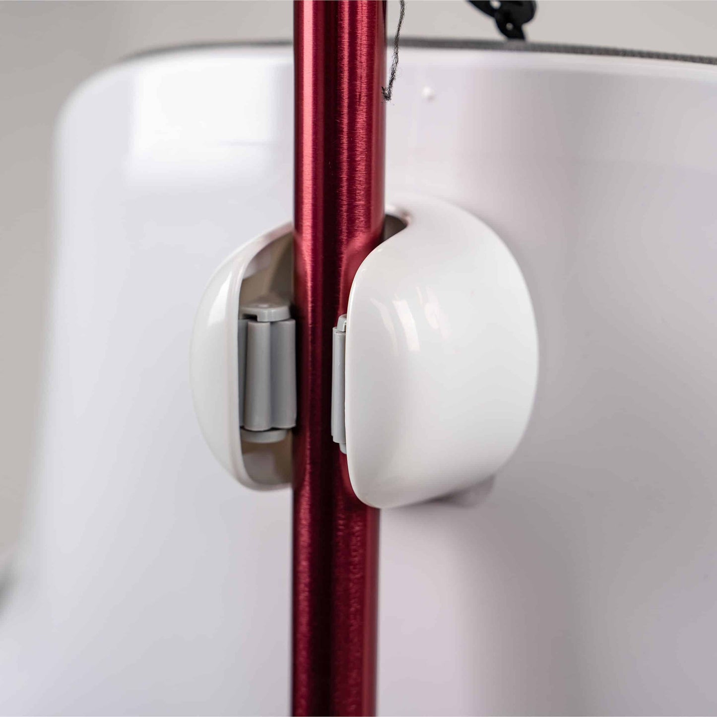 Close-up view of a red walking crutch securely fastened into the high-tension Robooter X40 rear mount cane holder.