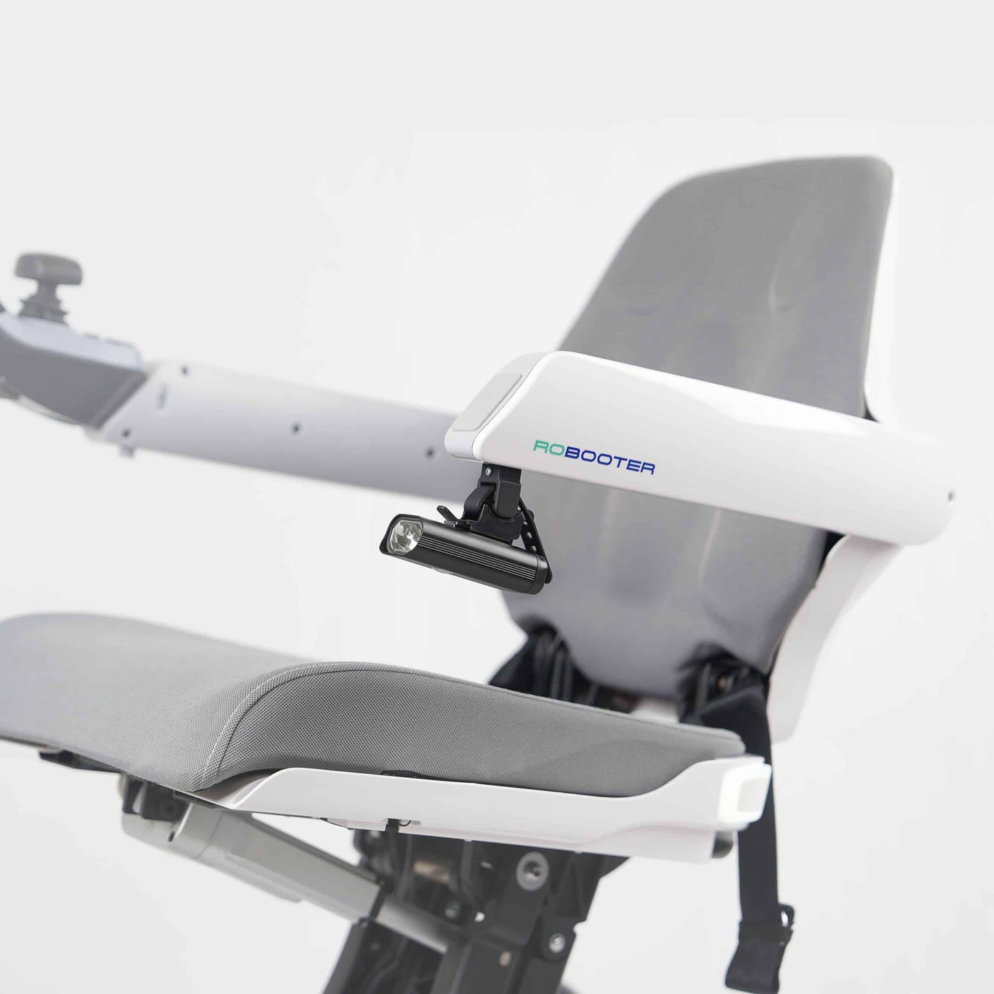 Side profile image showing the LED handrail lamp securely mounted to the armrest of the white Robooter X40 wheelchair for enhanced low-light safety.