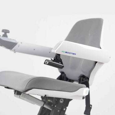 Robooter X40 headlamp fitted below the armrest of a white power chair