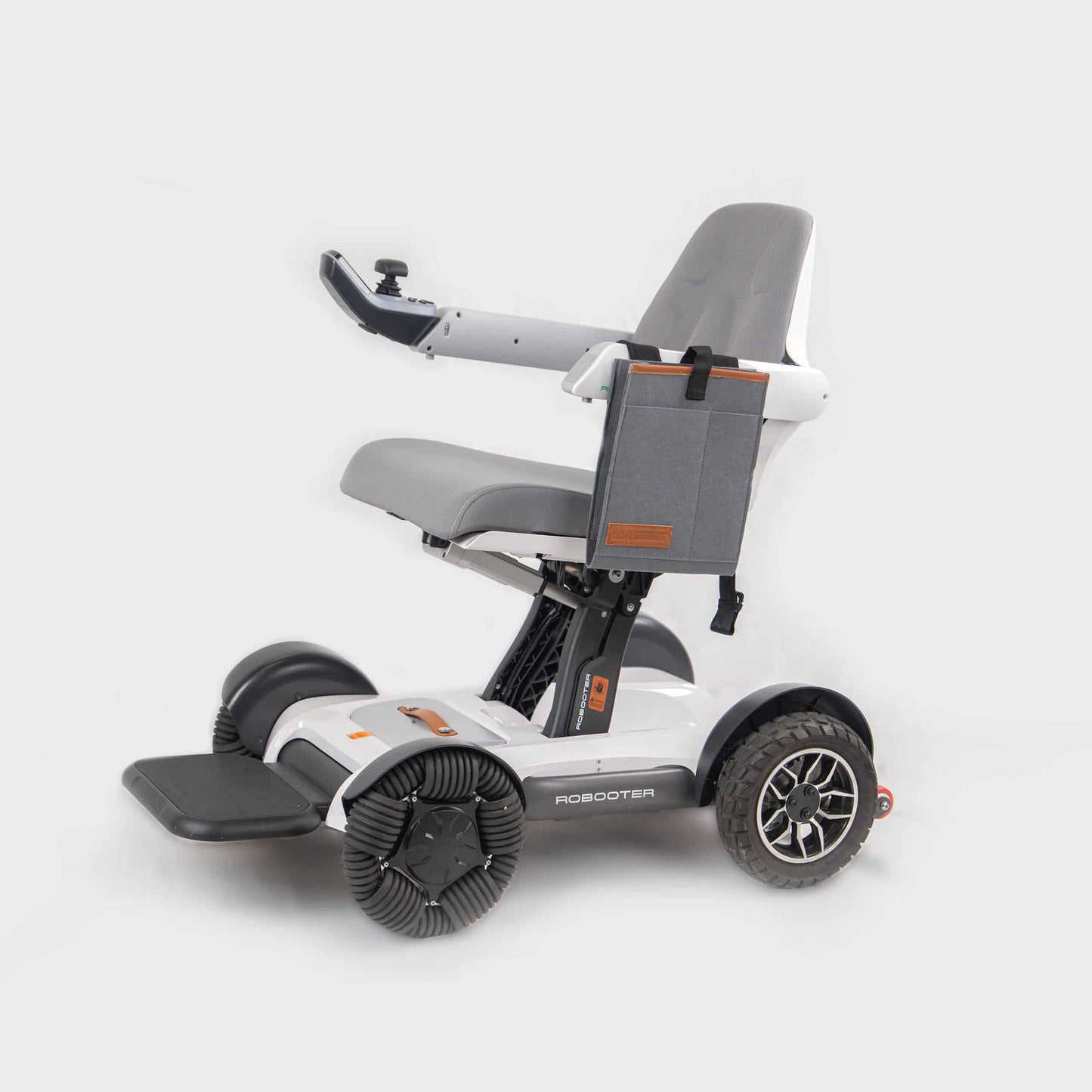 Side profile view of the sleek grey Robooter X40 electric wheelchair featuring the specialized side armrest bag securely mounted for low-profile storage.